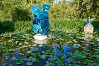 20241103174514_Blue_Glass_Sculpture_in_Lily_Pond