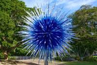 Blue glass sculpture in garden 