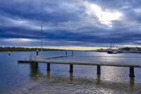 Pier under dramatic cloudy skies 