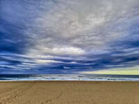 Stormy beach under dramatic clouds 