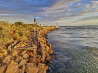 Rocky pier at golden sunset 